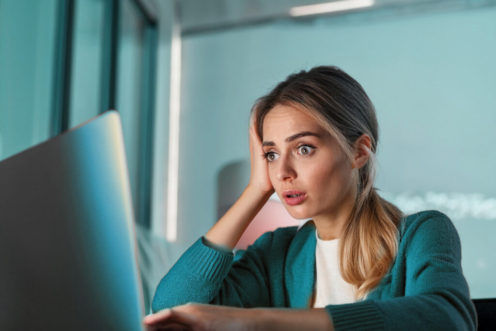 Tired woman looking at a laptop